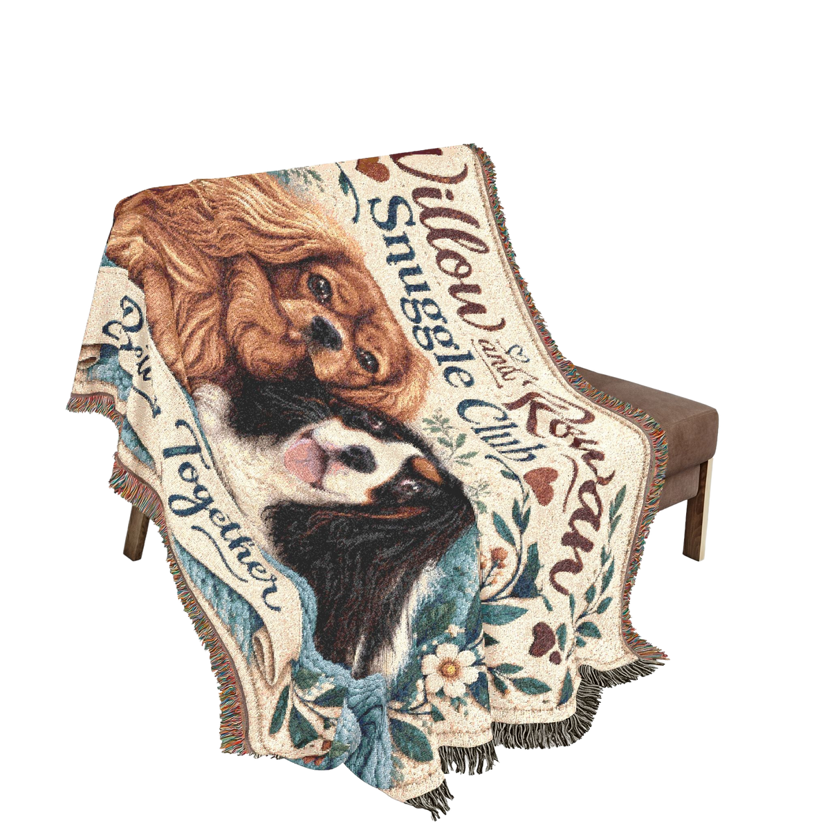 Willow & Rowan Snuggle Club woven blanket draped over a chair, showing the two Cavaliers and fringed edges.